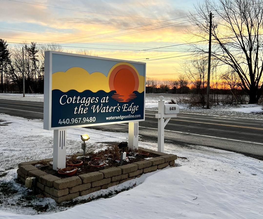 Cottages at the Water's Edge sign near the road.