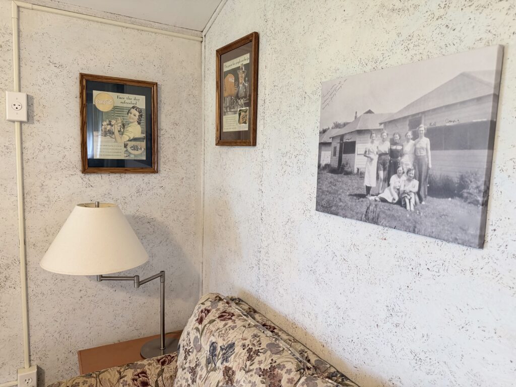 Vintage magazines and a 1936 image of Matilde Lemire, Therese Hoffman's mother in front of Cottages 4, 5, and 6.