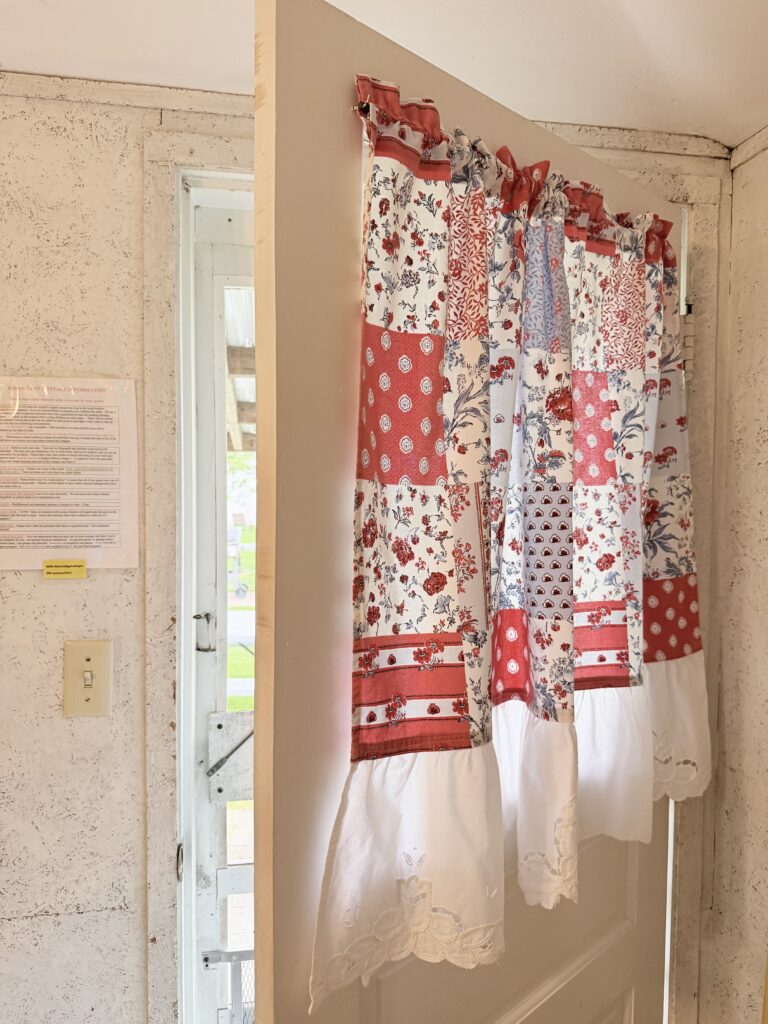 Hand sewn curtain on the front door of Cottage 5.