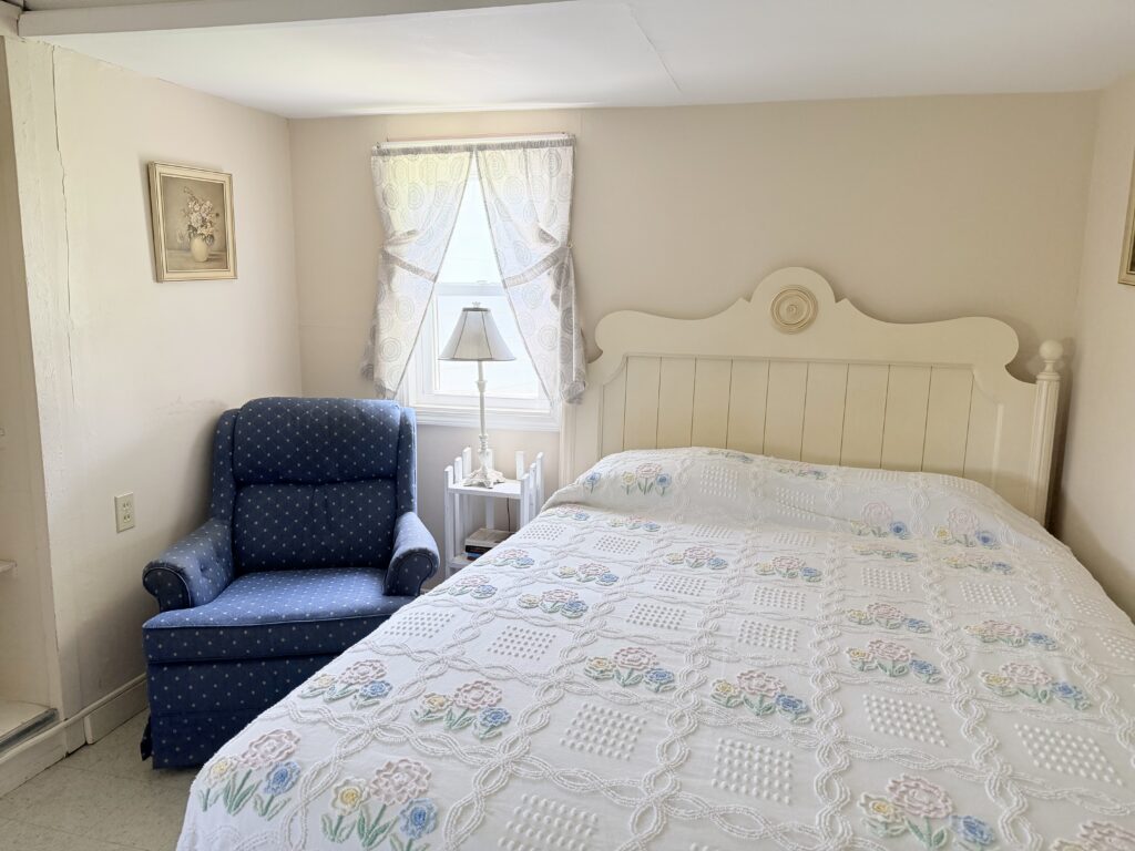 Cozy reading corner and queen size bed in Cottage 4.