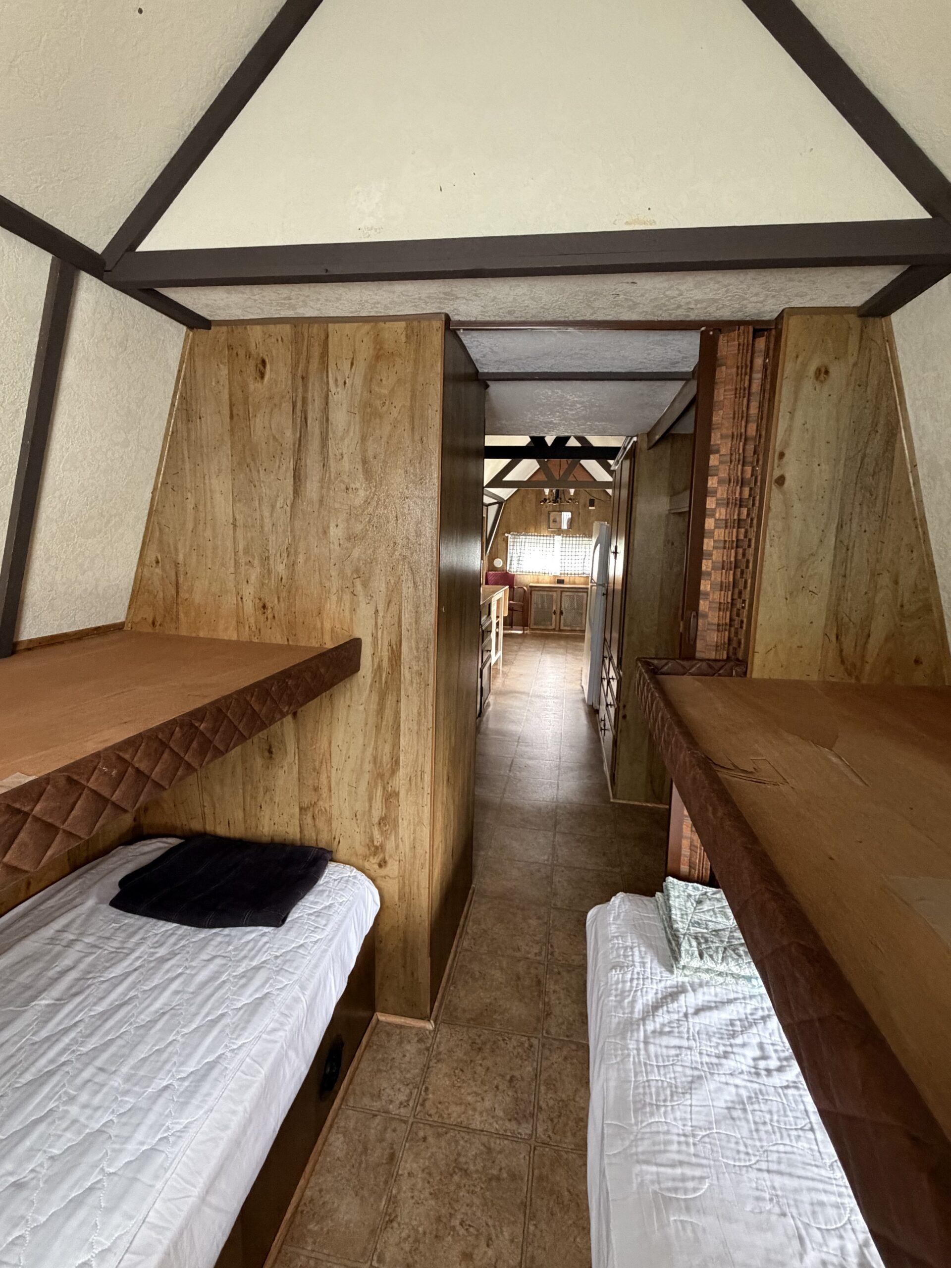 Twin beds on the bottom, light weight storage on the top bunks.